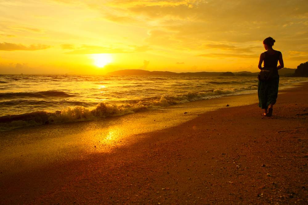 woman enjoying the scenery of the beach