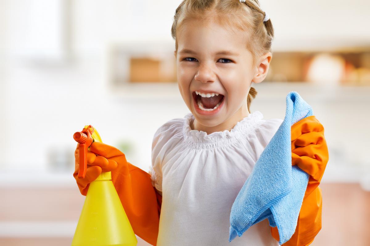 A girl with cleaning materials representing cleaning up after yourself.